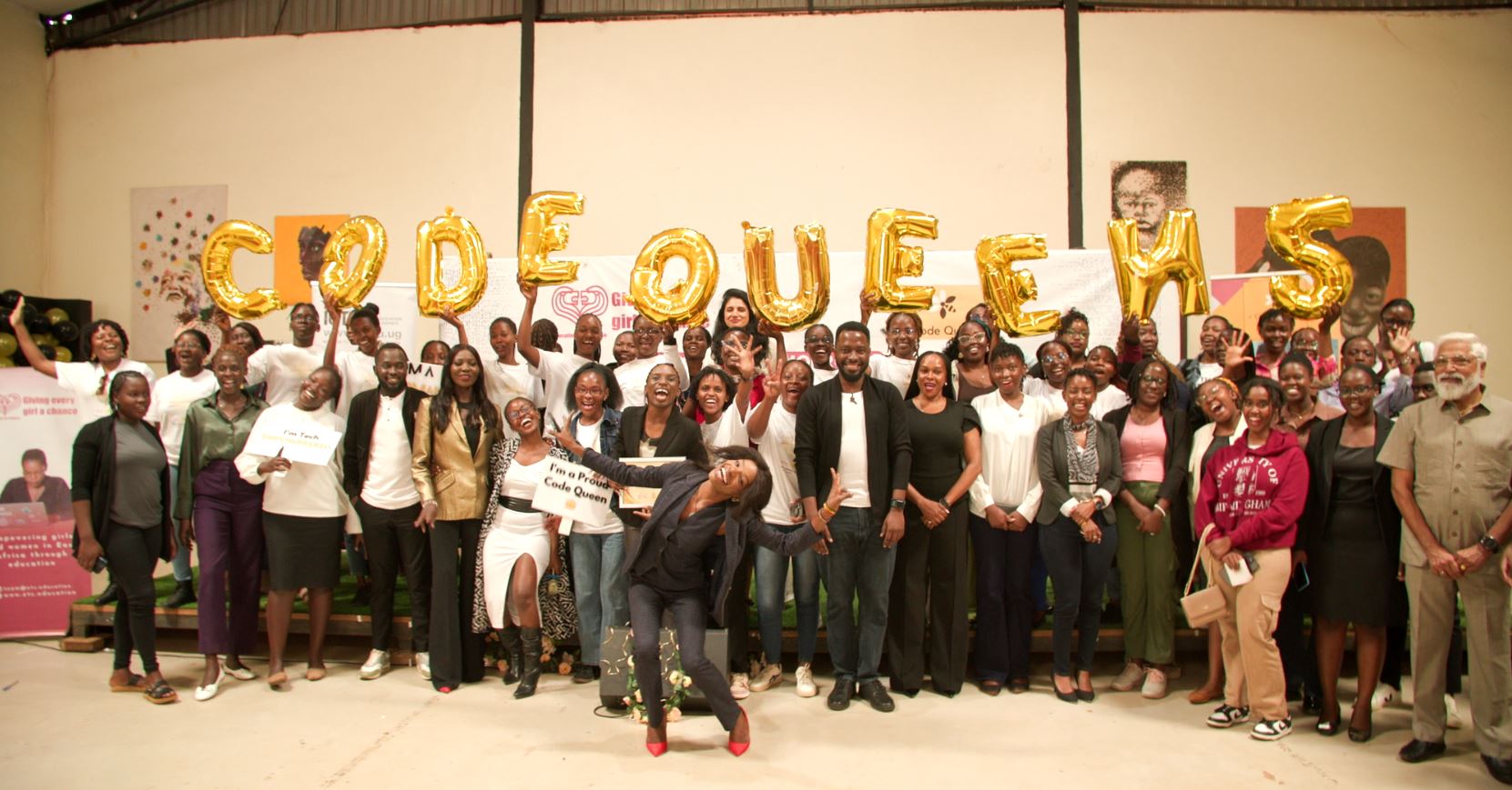 Code Queen graduation ceremony with golden balloons and celebrating graduates