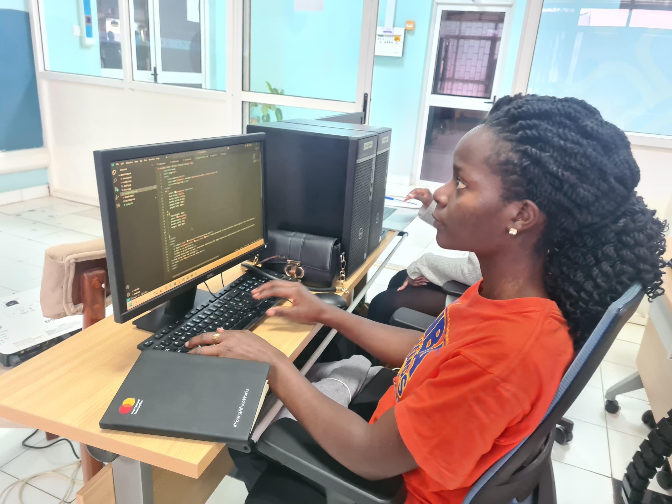 Student learning to code at computer workstation